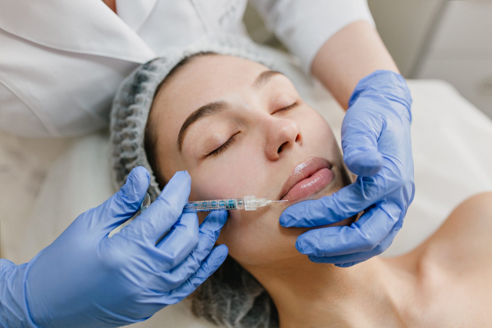 Closeup portrait of beautiful woman during cosmetology therapy in beauty salon. Botox, lips, injecting, professional procedures, lifting, rejuvenation, modern devices, healthcare.